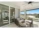 Relaxing screened patio with fan, comfortable seating, and sliding glass doors to indoors at 13916 Destin Beach Ln, Orlando, FL 32827