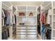 Well-organized walk-in closet with custom shelving, drawers, and ample storage space for clothing and accessories at 13916 Destin Beach Ln, Orlando, FL 32827
