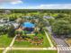Aerial view of community park entrance, playground, pool, parking, and recreational amenities at 14136 Magnolia Glen Cir, Orlando, FL 32828