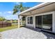 This covered back patio overlooks a scenic yard with a pond view at 14136 Magnolia Glen Cir, Orlando, FL 32828