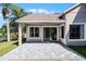 Covered back patio with a scenic fenced-in yard and sliding glass doors at 14136 Magnolia Glen Cir, Orlando, FL 32828
