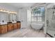 Bright primary bathroom with soaking tub, shower, and dual sink vanity at 14136 Magnolia Glen Cir, Orlando, FL 32828