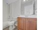 Bright bathroom features a shower and tub combo with light wood-look flooring and updated vanity at 14136 Magnolia Glen Cir, Orlando, FL 32828