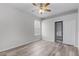 Neutral bedroom features ceiling fan, wood floor, closet and large window at 14136 Magnolia Glen Cir, Orlando, FL 32828
