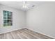 Bright bedroom features updated flooring, ceiling fan and a large window at 14136 Magnolia Glen Cir, Orlando, FL 32828