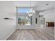 Dining area featuring laminate flooring, large windows for natural light, and an elegant chandelier at 14136 Magnolia Glen Cir, Orlando, FL 32828