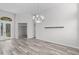 Bright dining room with laminate floors and a modern chandelier, offering open access to other rooms at 14136 Magnolia Glen Cir, Orlando, FL 32828
