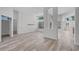 Bright dining space featuring wood-look flooring, arched entryways, and views of the outdoor area at 14136 Magnolia Glen Cir, Orlando, FL 32828