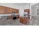 Well-lit kitchen with stainless steel appliances, granite countertops, and a convenient center island at 14136 Magnolia Glen Cir, Orlando, FL 32828