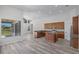 Modern open kitchen featuring granite counters, stainless appliances, a center island, and wood-look flooring at 14136 Magnolia Glen Cir, Orlando, FL 32828