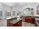 Spacious kitchen featuring granite countertops, stainless steel appliances, and a breakfast bar area at 14136 Magnolia Glen Cir, Orlando, FL 32828
