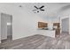 Open-concept living space with hardwood flooring, leading to a modern kitchen at 14136 Magnolia Glen Cir, Orlando, FL 32828