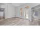 Bright, open living room with stylish laminate flooring, arched windows, and a clear view to the front entrance at 14136 Magnolia Glen Cir, Orlando, FL 32828