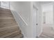 Staircase with white risers and wood-look flooring at 14136 Magnolia Glen Cir, Orlando, FL 32828