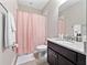 Well-lit bathroom features granite countertops, neutral walls, and a shower with a patterned curtain at 14554 Winter Stay Dr, Winter Garden, FL 34787