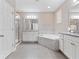 Bathroom featuring double vanities, a soaking tub, and a glass-enclosed shower, creating a spa-like oasis at 14554 Winter Stay Dr, Winter Garden, FL 34787