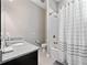 Bathroom featuring modern fixtures, vanity with granite counters, and a shower with tiled walls at 14554 Winter Stay Dr, Winter Garden, FL 34787