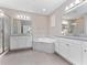 Bright bathroom with double vanities, soaking tub, and glass shower, perfect for relaxation at 14554 Winter Stay Dr, Winter Garden, FL 34787