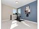 Bright bedroom showcasing exercise equipment, a mounted display shelf, and a two toned color scheme at 14554 Winter Stay Dr, Winter Garden, FL 34787