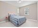 Charming bedroom featuring a comfortable bed, neutral walls, and a window with natural light at 14554 Winter Stay Dr, Winter Garden, FL 34787