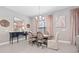 Elegant dining room features stylish furniture, decor, natural light, and neutral color palette at 14554 Winter Stay Dr, Winter Garden, FL 34787