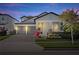 Charming two-story home featuring a three-car garage, manicured landscaping, and a welcoming front porch at 14554 Winter Stay Dr, Winter Garden, FL 34787
