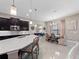 Open-concept kitchen and dining area with modern light fixtures, countertops, and neutral color palette at 14554 Winter Stay Dr, Winter Garden, FL 34787