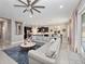 Bright and airy living space with an open layout, large sectional sofa, kitchen view, and dining area at 14554 Winter Stay Dr, Winter Garden, FL 34787