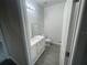 Bathroom includes a gray-tiled floor, modern vanity, and toilet at 1463 1St St, Orlando, FL 32824