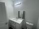 Updated bathroom featuring a vanity with drawers, a modern mirror, and a toilet at 1463 1St St, Orlando, FL 32824