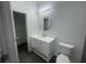 Stylish bathroom featuring a white vanity, round mirror, modern lighting, and tile floors at 1463 1St St, Orlando, FL 32824