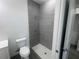 Bathroom with tile shower and white fixtures at 1463 1St St, Orlando, FL 32824