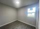 Bedroom with tile flooring, a window, neutral paint, and a light fixture at 1463 1St St, Orlando, FL 32824