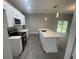 Open concept kitchen with stainless steel appliances and a large kitchen island at 1463 1St St, Orlando, FL 32824