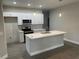 Modern kitchen featuring white cabinets, stainless steel appliances, and a center island with a sink at 1463 1St St, Orlando, FL 32824