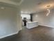 Spacious living area with wood-look tile flooring, recessed lighting, and a view of the modern kitchen at 1463 1St St, Orlando, FL 32824