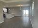 Spacious living area with wood-look tile flooring, recessed lighting, and a view of the sliding glass doors at 1463 1St St, Orlando, FL 32824
