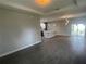 Spacious living area with wood-look tile flooring, recessed lighting, and a view of the sliding glass doors at 1463 1St St, Orlando, FL 32824