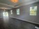 Bright, open living room with tray ceilings, tile floors, and natural light from large windows at 1463 1St St, Orlando, FL 32824