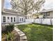 This backyard features a manicured lawn, stone pathway, and a deck perfect for outdoor entertaining at 1513 Pinecrest Pl, Orlando, FL 32803