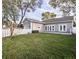 Expansive backyard featuring a lush lawn, privacy fence, and easy access to the house at 1513 Pinecrest Pl, Orlando, FL 32803