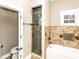 A charming bathroom with a glass enclosed shower, tiled walls, and natural light at 1513 Pinecrest Pl, Orlando, FL 32803