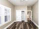 This bedroom features a ceiling fan, a window with shutters, dark wood floors, and neutral paint at 1513 Pinecrest Pl, Orlando, FL 32803