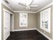 This bedroom features a ceiling fan, a window with shutters, dark wood floors, and neutral paint at 1513 Pinecrest Pl, Orlando, FL 32803