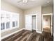 This bedroom features a ceiling fan, a window with shutters, dark wood floors, and neutral paint at 1513 Pinecrest Pl, Orlando, FL 32803