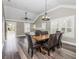 Elegant dining room with hardwood floors, plantation shutters, and modern light fixture at 1513 Pinecrest Pl, Orlando, FL 32803