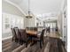 Spacious dining area with a vaulted ceiling, modern chandelier, and an adjacent kitchen at 1513 Pinecrest Pl, Orlando, FL 32803