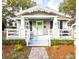 Charming bungalow with a covered porch, columns, decorative trim, and a vibrant green front door at 1513 Pinecrest Pl, Orlando, FL 32803