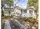 Charming single story home with a landscaped front yard and decorative front porch at 1513 Pinecrest Pl, Orlando, FL 32803