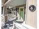A charming covered front porch features a porch swing, sconces, and a bright green front door at 1513 Pinecrest Pl, Orlando, FL 32803
